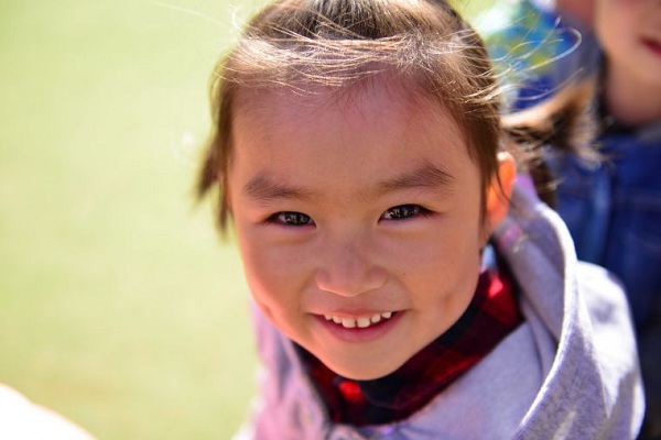 Grinning faces on World Smile Day