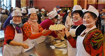 Thousands eating pickled stuffed cabbage dumplings break world record