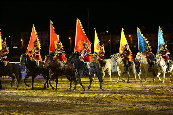 People in traditional Mongolian clothing are pictured on horseback during the opening ceremony of the Fifth International Equestrian Festival in Hohhot, Inner Mongolia autonomous region on Sept 21.jpg