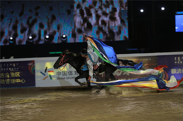 A jockey performs stunts at the opening ceremony of the Fifth International Equestrian Festival in Hohhot, Inner Mongolia autonomous region on Sept 21.jpg