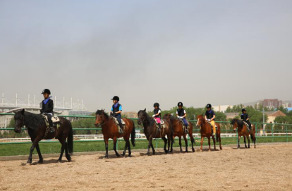 Teenagers ride horses in Hohhot.png