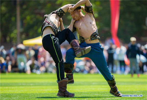 Two wrestlers of Hohhot Minzu College compete at a Nadam fair of the school in Hohhot.jpg