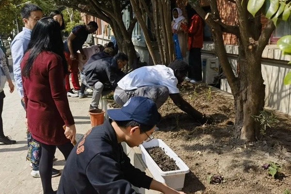 Intl students plant herbs on campus to celebrate National Tree Planting Day